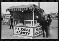 [Untitled photo, possibly related to: Popcorn man and his wife studying the map, county fair, Gonzales, Texas] by Russell Lee