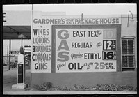 [Untitled photo, possibly related to: Sign at filling station which also sells liquor, Waco, Texas] by Russell Lee