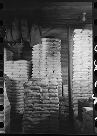 [Untitled photo, possibly related to: Flour in railroad freight car at wholesale grocers, San Angelo, Texas] by Russell Lee
