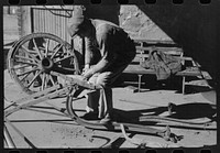 [Untitled photo, possibly related to: Blacksmith's helper disassembling plow belonging to Pomp Hall,  tenant farmer from Creek County, Oklahoma. Blacksmith shop is in Depew, Oklahoma. See general caption number 23] by Russell Lee