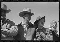 [Untitled photo, possibly related to: Group of spectators at sideshow watching man unloosen himself from chains.  San Angelo Fat Stock Show, San Angelo, Texas] by Russell Lee