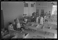 Wives of migratory laborers in the laundry room at the Agua Fria Migratory Labor Camp, Arizona by Russell Lee