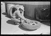 Changing tire at the garage. Pie Town, New Mexico by Russell Lee