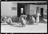[Untitled photo, possibly related to: Changing tire at the garage. Pie Town, New Mexico] by Russell Lee