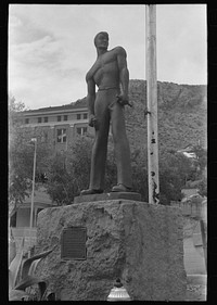 [Untitled photo, possibly related to: Miners monument in Bisbee, Arizona. This monument is cast in cement, sprayed with molten copper and mounted on a block of Colorado granite used for miners' drilling contests in the nineties. The monument was erected in 1935] by Russell Lee