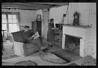 [Untitled photo, possibly related to: Homesteader and his wife in the living room of their new adobe house. This couple came out seven years ago from Oklahoma and lived in a log cabin until building this winter the adobe house. Pie Town, New Mexico] by Russell Lee