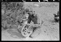 [Untitled photo, possibly related to: Jack Whinery grinding pinto beans for chicken feed, Pie Town, New Mexico] by Russell Lee