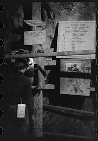 Miner using telephone at 500-foot level at gold mine. Mogollon, New Mexico by Russell Lee
