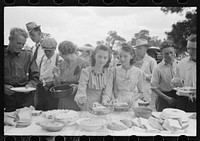 Helping the plates at dinner on the grounds, all day community sing. Pie Town, New Mexico by Russell Lee