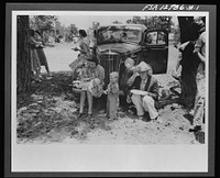 Farm folks eating dinner at the all-day community sing. Pie Town, New Mexico by Russell Lee