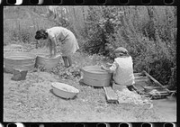 [Untitled photo, possibly related to: Washing along the irrigation ditch, Chamisal, New Mexico] by Russell Lee