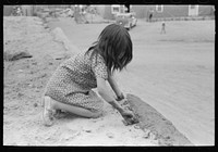 [Untitled photo, possibly related to: Spanish-American girl plastering edge of roof of adobe house. Costilla, New Mexico] by Russell Lee