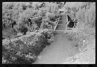 Irrigation ditch carried across an arroyo. Taos County, near Dixon, New Mexico by Russell Lee