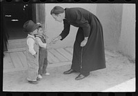 [Untitled photo, possibly related to: Catholic priest greeting small Spanish-American boy after Mass. Trampas, New Mexico] by Russell Lee