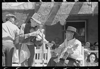 Spanish-American musicians playing at the fiesta at Taos, New Mexico by Russell Lee