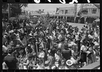 Crowd of people watching the dance at fiesta, Taos, New Mexico by Russell Lee