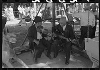 [Untitled photo, possibly related to: The music for the merry-go-round. Fiesta, Taos, New Mexico] by Russell Lee