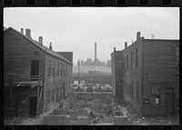 Condemned houses in  section of Chicago, Illinois, with steel mills in background by Russell Lee