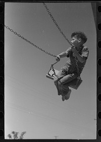 [Untitled photo, possibly related to: Children playing on slide at FSA (Farm Security Administration) labor camp, Caldwell, Idaho] by Russell Lee