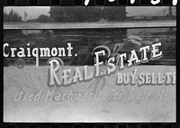 Walla Walla County, Washington. A real estate office advertising used farm machinery for sale by Russell Lee