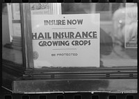 Walla Walla County, Washington. An insurance office window advertising hail insurance for growing crops by Russell Lee