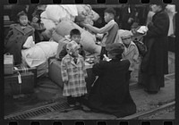 Los Angeles, California. The evacuation of the Japanese-Americans from West Coast areas under U.S. Army war emergency order. Evacuees waiting with their luggage at the old Santa Fe station for a train to take them to Owens Valley by Russell Lee