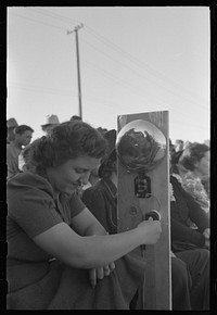 Ringing gong at boxing match at the annual field day of the FSA (Farm Security Administration) farmworkers community, Yuma, Arizona by Russell Lee