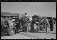 Santa Anita reception center, Los Angeles County, California. Baggage of Japanese-Americans being inspected as they arrive from West Coast areas under U.S. Army war emergency order by Russell Lee