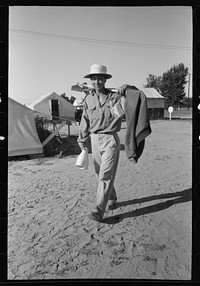 Nyssa, Oregon. FSA (Farm Security Administration) mobile camp. Japanese-Americans dumping garbage. A Japanese-American farm worker who lives at the camp by Russell Lee