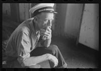 A seaman aboard the Norfolk-Cape Charles ferry. Sourced from the Library of Congress.