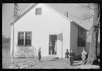 [Untitled photo, possibly related to: Small children waiting for their older brothers and sisters to be let out of school for lunch. Ledyard, Connecticut]. Sourced from the Library of Congress.