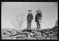 Small children waiting for their older brothers and sisters to be let out of school for lunch. Ledyard, Connecticut. Sourced from the Library of Congress.