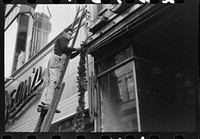 [Untitled photo, possibly related to: Hanging Christmas decorations in Providence, Rhode Island]. Sourced from the Library of Congress.