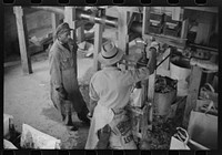 Filling paper sacks with hot rosin at a turpentine works in Statesboro, Georgia. Sourced from the Library of Congress.