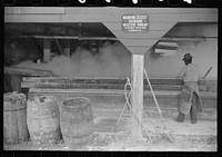 Filtering hot rosin through sieves at a turpentine works in Statesboro, Georgia. Sourced from the Library of Congress.