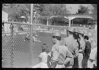 Soldiers from Fort Benning watching bathers in pool at Idle Hour park near Phenix City, Alabama. Sourced from the Library of Congress.