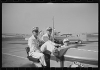 Washington, D.C. Workers at the municipal airport riding a little truck used to haul baggage and freight around the field. Sourced from the Library of Congress.