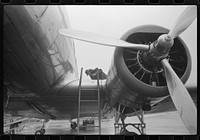 Checking the fuel on a plane at the municipal airport on a rainy day, Washington, D.C.. Sourced from the Library of Congress.
