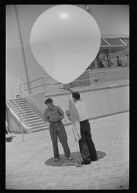 [Untitled photo, possibly related to: Preparing to send up the weather balloon at the weather bureau at the municipal airport in Washington, D.C.]. Sourced from the Library of Congress.