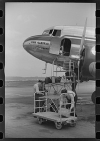 Loading baggage on a plane at the municipal airport in Washington, D.C.. Sourced from the Library of Congress.