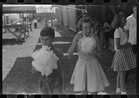 Eating candy floss at a small lodge carnival near Bellows Falls, Vermont. Sourced from the Library of Congress.