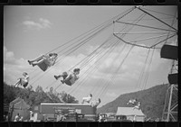 [Untitled photo, possibly related to: On the merry-go-round of a small American Legion carnival just outside Bellows Falls, Vermont]. Sourced from the Library of Congress.