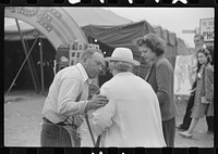 [Untitled photo, possibly related to: Tintype photographer trying to make a sale at the Champlain Valley Exposition, Essex Junction, Vermont]. Sourced from the Library of Congress.