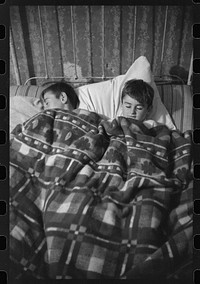 [Untitled photo, possibly related to: Two of the Gaynor children going to bed on their farm near Fairfield, Vermont]. Sourced from the Library of Congress.