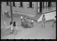 Orange vendor in street in Barranquitas, Puerto Rico. Sourced from the Library of Congress.