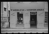 Farmacia La Esperanza (Pharmacy of Hope), a small drug store in Barranquitas, Puerto Rico. Sourced from the Library of Congress.
