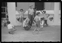 French Village, a small settlement on St. Thomas Island, Virgin Islands. Boys playing marbles outside of a general store. Sourced from the Library of Congress.