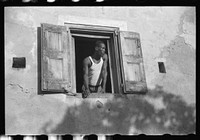 Worker who lives on one of the steep streets in Charlotte Amalie, St. Thomas, Virgin Islands. Sourced from the Library of Congress.