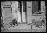 [Untitled photo, possibly related to: Children playing with their Christmas toys on a side street, Charlotte Amalie, St. Thomas, Virgin Islands]. Sourced from the Library of Congress.