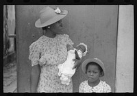 Charlotte Amalie, St. Thomas Island, Virgin Islands. Mother and children waiting on the main street on Sunday. Sourced from the Library of Congress.
